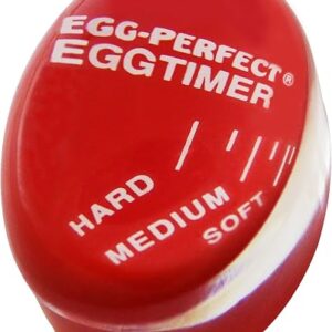Boiled egg timer in red, the Norpro Egg Perfect disc sitting in a pan of water beside eggs